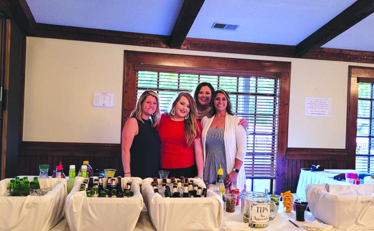 Megan Broome/The Clayton Tribune. Andria Robinson, Ashley Cabe, Natalie Dillard and Jo Flores work hard as they listen to the live music and enjoy the festivities at The Dillard House on Sunday.