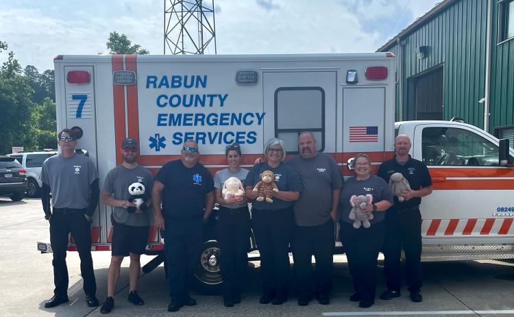 Submitted photo. Rabun County EMS receives a donation of stuffed animals from The Ryan Batchelder Foundation “Little Hugs.” Holding some of the donations are Paramedic Gary Jones; Paramedic Jackson Fischer; Paramedic David Lyle; AEMT Annie Lewis; Lieutenant Tammy Jones; EMT-I Josh Hickox; Paramedic Elisha Higgins; and Lieutenant David Cavender.