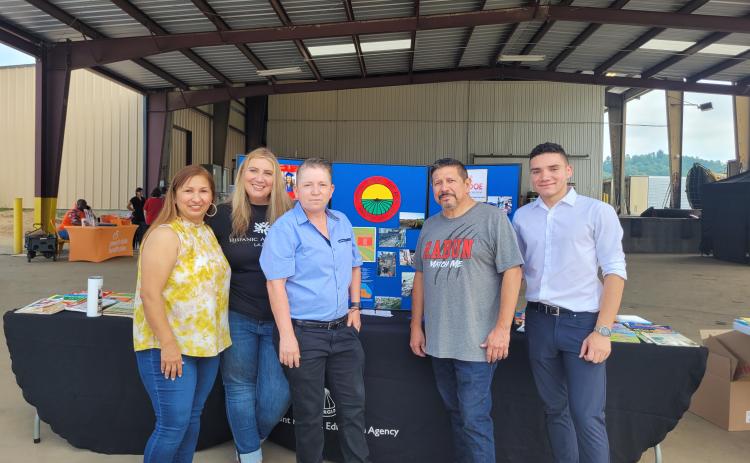 Megan Broome/The Clayton Tribune. Paula Macedo, Migrant Program Liaison for Gainesville City Schools, Vanesa Sarazua with Hispanic Alliance, Evelyn Arevalo, Region 1 Migrant Education Program Recruiter for the Georgia Department of Education, Roberto Aguilar, Migrant SSP for Rabun County Schools, and Rodney Santana, volunteer from Hall County, participate in the Hispanic Information and Health Fair on July 22 at the Osage Farms packing house in Rabun Gap.