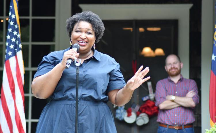 Enoch Autry/The Clayton Tribune. Democratic nominee Stacey Abrams addresses the crowd at the Parker Ranch on July 29. Standing behind Abrams is Charlie Bailey, who seeks the elected position of lieutenant governor.