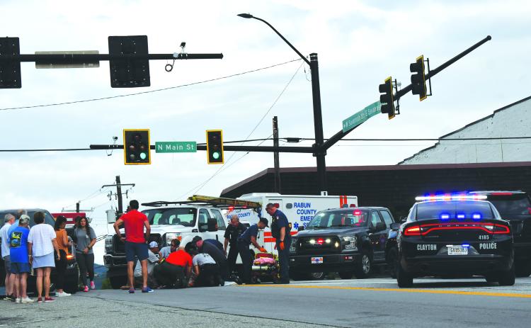 Enoch Autry/The Clayton Tribune. Rabun County emergency personnel assist a pedestrian who was struck by a vehicle in downtown Clayton.