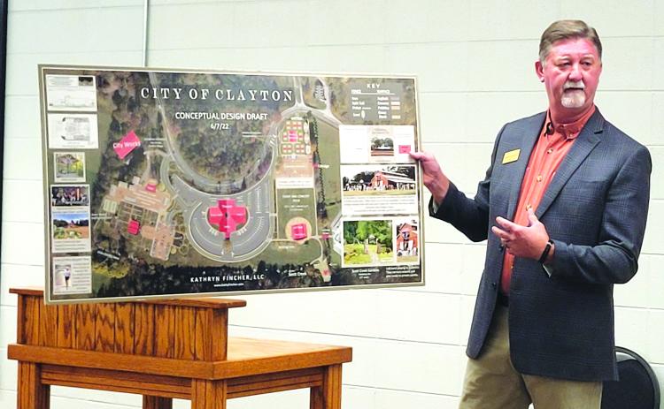 Megan Broome/The Clayton Tribune. Clayton Mayor Kurt Cannon unveils plans for the proposed new complex on the city’s 18-acre property at a city council meeting in August. Plans are to have a new city hall, theater, gardens, and concert area.