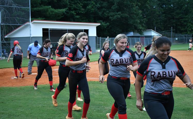 The Lady Cats celebrate a two-run home run from senior Mary Lovell (left) against Habersham Central.