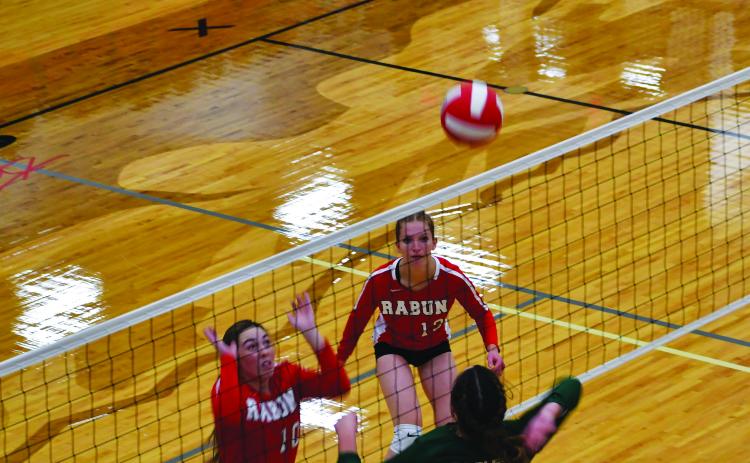 Luke Morey/The Clayton Tribune. RGNS sophomore Cathryn Carmack goes up for a kill against RCHS juniors Anna Raye Darnell and Mira Tinnefeld. The Lady Cats went 1-1 while the Eagles went 2-0.