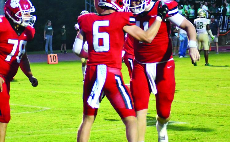 Enoch Autry/The Clayton Tribune. Senior Jaden Gibson (left) celebrates his fourth touchdown of the night with senior quarterback Keegan Stover (right) who ended with a record-setting eight passing touchdowns.