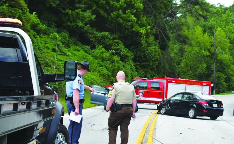 Megan Broome/The Clayton Tribune. Georgia State Patrol Trooper Brady Galloway and Rabun County Sheriff’s Office Sgt. Cody Sanders analyze the scene of a four-vehicle crash on Georgia 15 at File Street near George Eller Curve in Mountain City September 5.