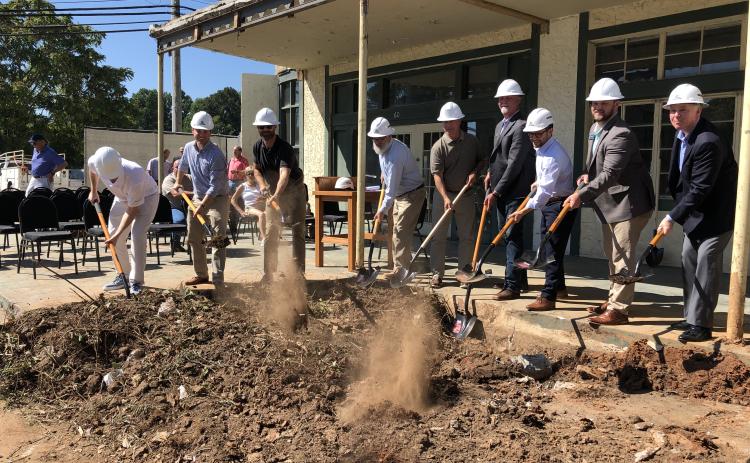 Tony Penrose/The Clayton Tribune. Mat Barnwell (left) Tyler Caswell, Jamie Langham, Micah McCracken, Stan Gunter, Clayton Mayor Kurt Cannon, Peter Evers, Sen. Bo Hatchett, and Rabun County Director of Development Rick Story break ground on the Bridge Creek Inn during a ceremony Sept. 21. It is expected to open Labor Day 2023.
