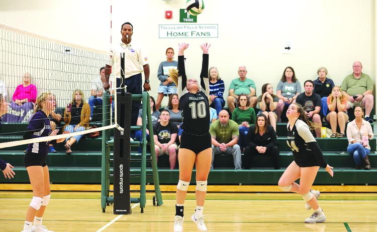 Courtesy of Austin Poffenberger. Senior Kitty Rodenas (center) sets the ball for junior Addy McCoy (right) during the Rocky Top Tournament