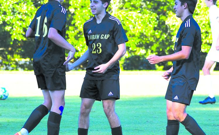 Luke Morey/The Clayton Tribune. Moteijus Samsonas (left) celebrates his goal with Marcello Gonzalez (middle) and Rafael Castillo (right) at the Eagles’ last home game on Sept. 13 against Asheville Christian Academy where the Eagles won 6-1. Samsonas is tied for second on the team in assists.