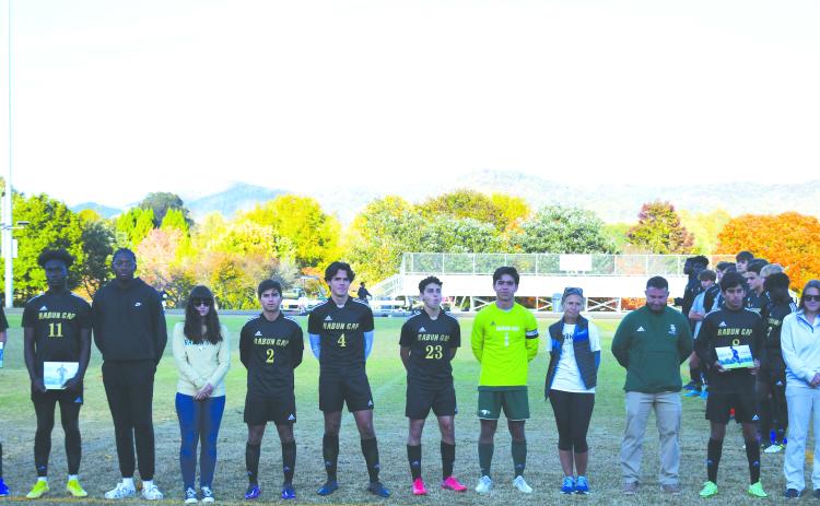 Luke Morey/The Clayton Tribune. The Rabun Gap-Nacoochee soccer seniors were honored before their last home game on Monday night. The seniors are from left, John Barta (14) with Keri Barta, Kyle Brako (11) with Tola Omatayo, Rafael Castillo (2) with Chelsea Dabrik and Guillermo Haro, Hugo Garcia (1) with Marcelo Gonzalez and Pam Weatherly, and Emilio Roman (8) with Mark Green and Alex Fagin.