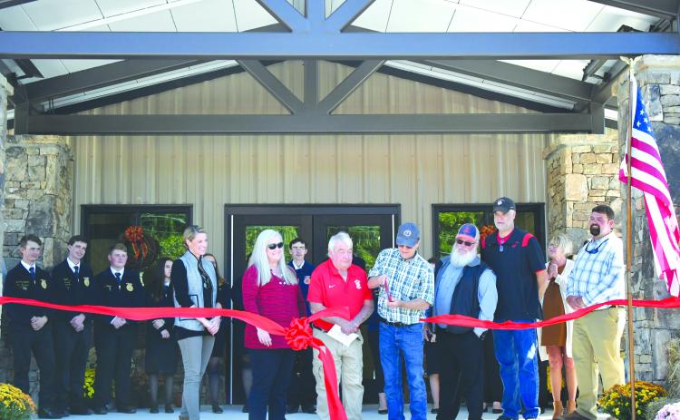 Enoch Autry/The Clayton Tribune. Rabun County Board of Education Chair and retired RCHS agriculture teacher Steve Cabe cuts the ribbon on the Rabun County Schools Agri-Science Center October 6. Pictured are Cabe with Rabun County FFA students; Board of Education Member Molly Lima; Rabun County Schools Superintendent Dr. April Childers; Rabun County Board of Education Members Wayne Stephens; Mark Beck; and Rabun County Board of Education Vice-Chair Curt Haban with Agriculture Education Instructor Clay Brown.