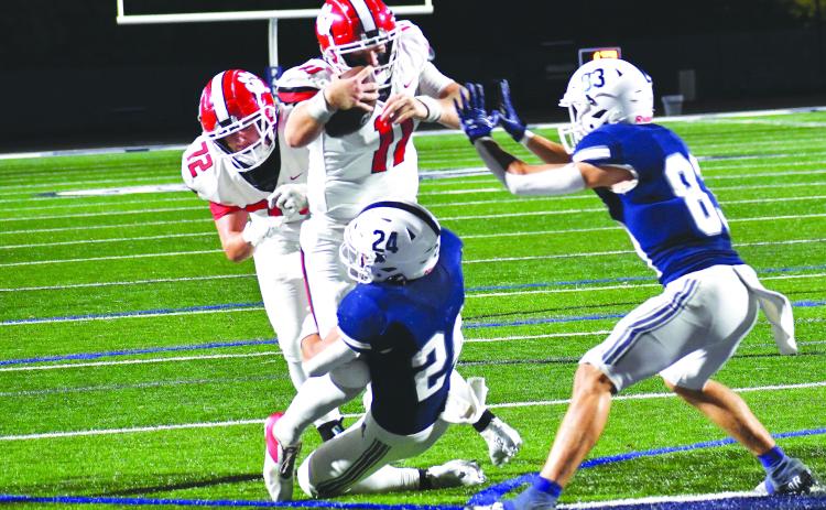 Luke Morey/The Clayton Tribune. RCHS senior quarterback Keegan Stover powers his way into the end zone as he is helped by a push from senior center Skip Speed (72).