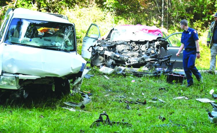 Megan Broome/The Clayton Tribune. Emergency personnel work at the scene of a Sept. 28 two-vehicle crash on Georgia 2 east of McWorter Lane in Rabun County just before the Georgia-South Carolina state line. Two female passengers from Franklin, N.C., suffered fatal injuries as a result of the crash and a Clayton man was life-flighted from the scene with reported serious injuries.