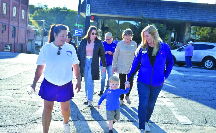Megan Broome/The Clayton Tribune. Laura Davis, Finnley Smith, Jekka Smith, Jenifer Kulow, Susan Kulow and Dena Crane participate in the Hope Walk in solidarity with those who have been affected by domestic violence to bring awareness to October as “Domestic Violence Awareness Month.”