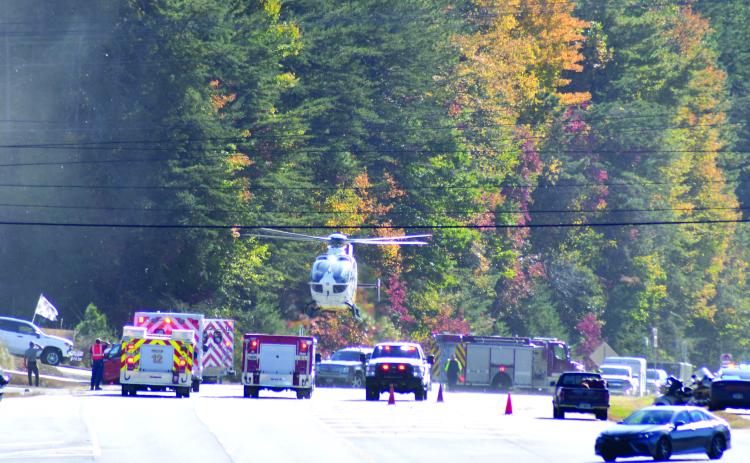 Enoch Autry/The Clayton Tribune. A helicopter lands on Georgia 15 at Seed Tick Road in Clayton Oct. 21 and emergency personnel work the scene following a crash involving a vehicle and motorcycle.