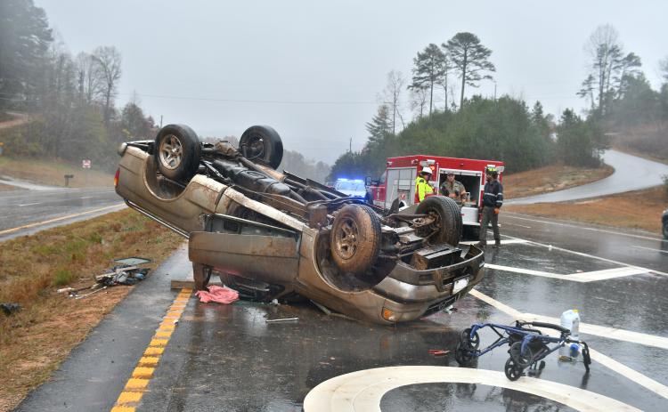 Megan Broome/The Clayton Tribune. First responders work the scene of a single vehicle crash for a vehicle that overturned on Ga. 15 at Razorback Lane in Lakemont Nov. 11. The driver, a Clarkesville, Ga. man, sustained possible minor injuries as a result of the crash.