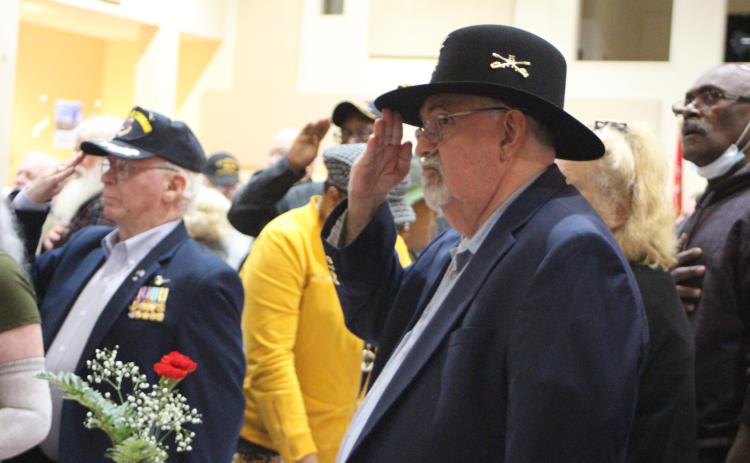 Megan Broome/The Clayton Tribune. Ray Kreiner, Army and 30-year veteran, salutes to honor fellow soldiers at the Veterans Appreciation Dinner Nov. 11, 2021.