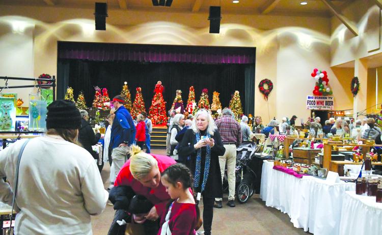 Luke Morey/The Clayton Tribune. Hundreds of visitors showed up to the Festival of Trees on Nov. 25 and 26 to see the 39 vendors who offered an array of items including mugs, wreaths, candles, award-winning BBQ sauce and paintings.