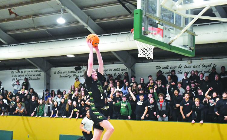 Luke Morey/The Clayton Tribune. Senior Theo Antinori ends the fast break with a dunk as the student section goes wild on Friday night. Antinori had 29 points on Friday before going off for 30 on Saturday.
