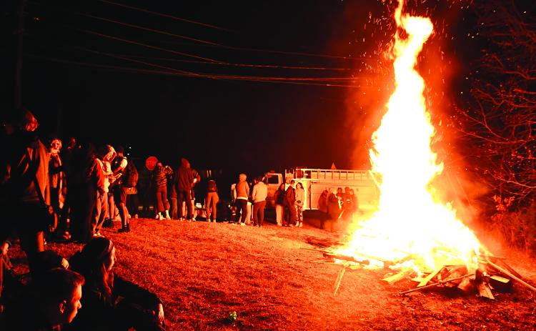 Megan Broome/The Clayton Tribune. Crowds of people from the community and students from Tallulah Falls School enjoy mingling and hanging out at the bonfire during the Town of Tallulah Falls Christmas Party Dec. 2.