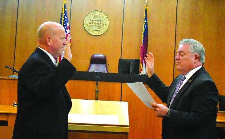 Megan Broome/The Clayton Tribune. James V. Blalock takes the oath of office as Rabun County magistrate judge as he is sworn-in by Judge Russell W. Smith.