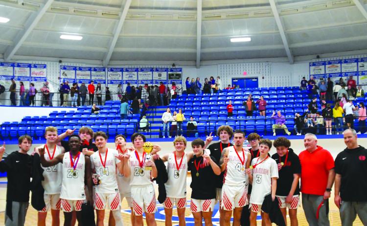Enoch Autry/The Clayton Tribune.  Senior Jayton Henry holds the trophy after he and his Rabun County Wildcat teammates defeat Union County 54-53 on Dec. 30 for the Battle of the States championship.
