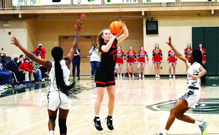 Luke Morey/The Clayton Tribune. RCHS junior Lucy Hood hits a shot as two Elbert defenders rush out to the three-point line. Elbert County won the Region 8 title 61-41 on Friday, Feb. 17. The No. 2 Lady Cats took on Pepperell on Tuesday, Feb. 21, in the first round of the GHSA state playoffs.
