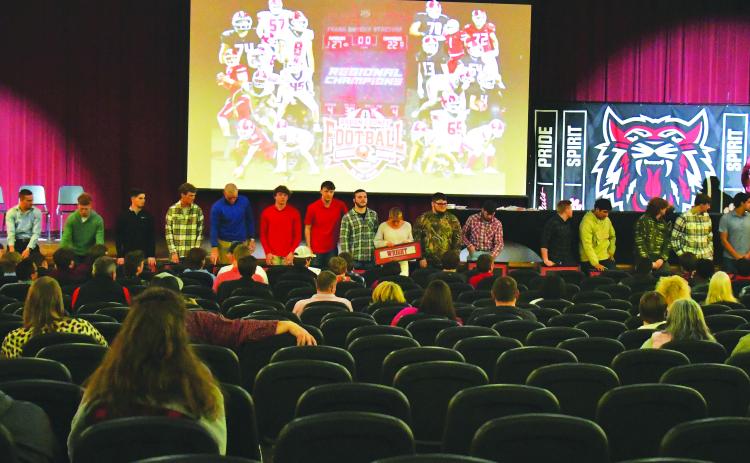 Luke Morey/The Clayton Tribune. On Sunday, Feb. 5, Rabun County High School honored the 2022 football team after their 12-1 season. RCHS head coach Michael Davis (pictured speaking) addressed the 19 seniors after their final season as  Wildcats. The seniors went 47-6 overall with a 16-0 region record. Pictured with the 19 seniors is senior student manager Molly Jo Wright (center).