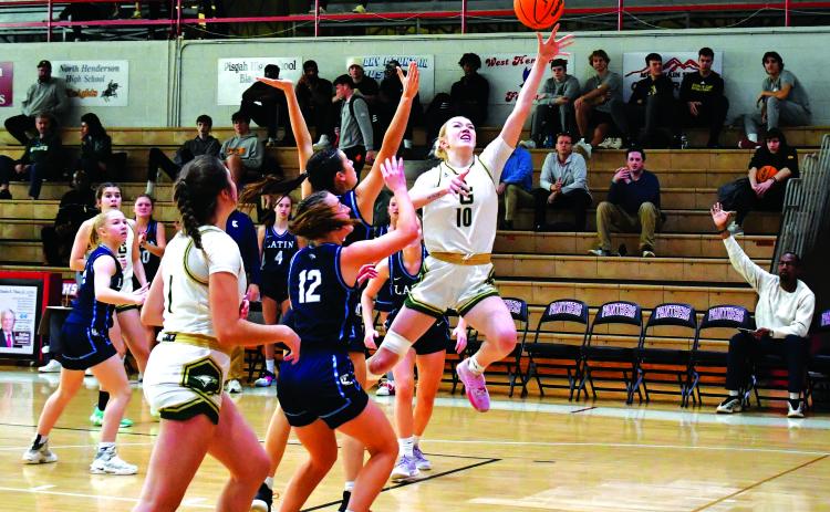 Luke Morey/The Clayton Tribune. Rabun Gap junior Monna Julkunen finishes through contact against Charlotte Latin on Saturday, Feb. 18. Julkunen scored 13 points, helping lead the Lady Eagles to a 63-33 victory, advancing to the NCISAA state semifinal round against Providence Day School on Feb. 21.