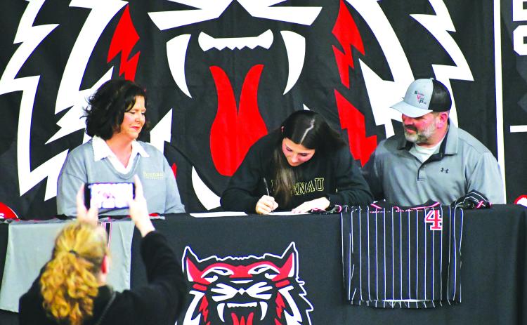 Luke Morey/The Clayton Tribune. Surrounded by parents Kim and Christian Lovell, Rabun County senior Mary Lovell signs her Letter of Intent on Tuesday, Jan. 31. Lovell, who has played softball and basketball at RCHS, will attend Brenau University for softball. In her senior softball season, Lovell hit .451 with five home runs for the Lady Cats.