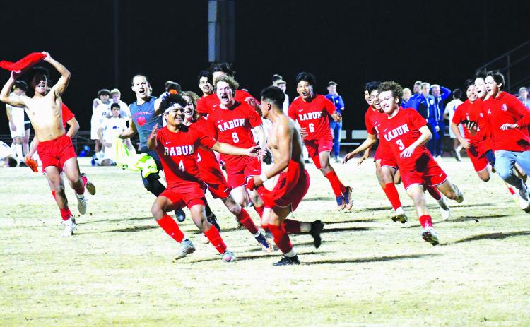 Luke Morey/The Clayton Tribune. With dejected Barrow Arts and Sciences Academy players in the background, the Rabun County Wildcats celebrate a victory in penalties. The game-winning penalty was scored by senior Ezequiel Ramos (pictured center with brother Rodolfo Ramos who is wearing No. 4) on a night where Rabun County honored its seniors. The Lady Cats also picked up a victory over BASA by cruising to a 3-1 win. The Rabun County boys and girls teams only have one more region game until the playoffs begin