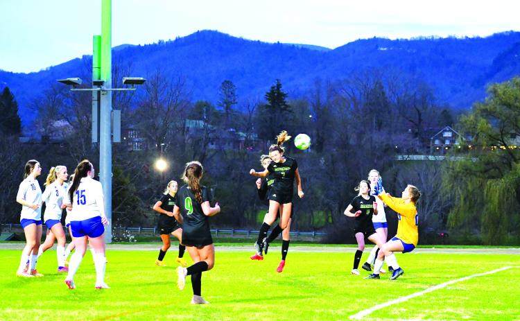 Luke Morey/The Clayton Tribune. Rabun Gap Lady Eagle junior Georgia Mattis heads the ball past the Highlands goalkeeper for the first goal of the night on Wednesday, March 8. Mattis has helped lead the Lady Eagles to a 4-0-1 start by scoring four goals in five games.