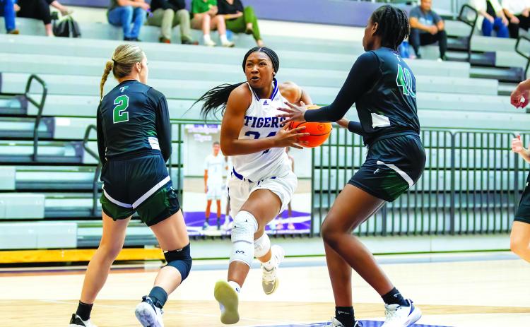 Kerry Gordon/Rome News-Tribune. Darlington's Jy Johnson attacks the paint against Tallulah Falls School defenders Breelyn Wood (2) and Tanisha Seymour in the first round of the GHSA state playoffs in Rome on Feb. 22. Darlington won 57-36 as the visiting Lady Indians saw their season come to a close, finishing with a 7-17 record, led by Region Player of the Year Denika Lightbourne.