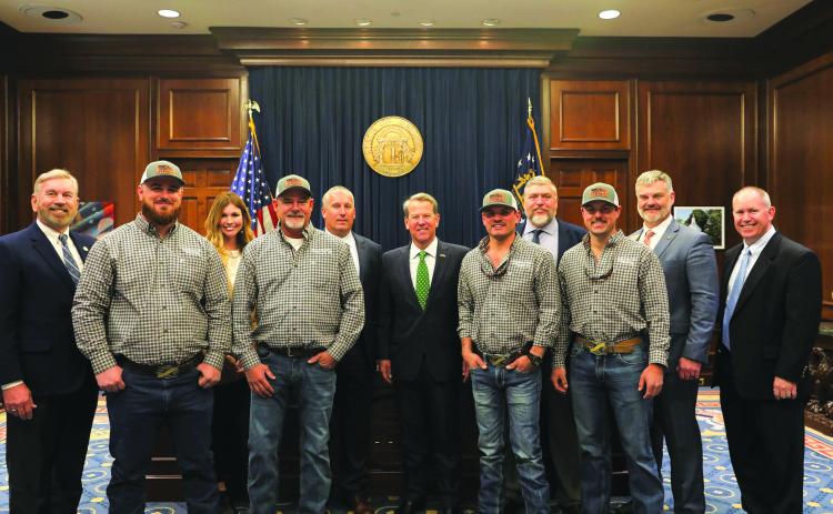 Submitted photo. Pictured (from left) are Terry Rogers; Robert Morris, team member; Mary Beth Horton, Community Relations Ambassador; Chris Chapman, team coach; Bryan Ferguson, HEMC President & CEO; Gov. Brian Kemp; Dillon Welborn, team member; Josh Allen, HEMC V.P., Engineering & Operations; Tucker Dyer, team member; Rep. Victor Anderson; and Tommy Thurmond HEMC V.P. Member & Community Relations.