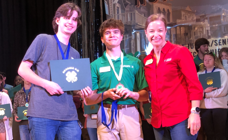 Photo courtesy Rabun County 4-H. Rabun County ninth grader Peyton Hicks (left) won first place in the Georgia 4-H Northeast District Project Achievement for veterinary science at Rock Eagle 4-H Center from March 10-12. Hicks is shown with Stephens County’s Luke Roesch, Northeast District senior board member; and Denise Everson, Northeast District extension director.