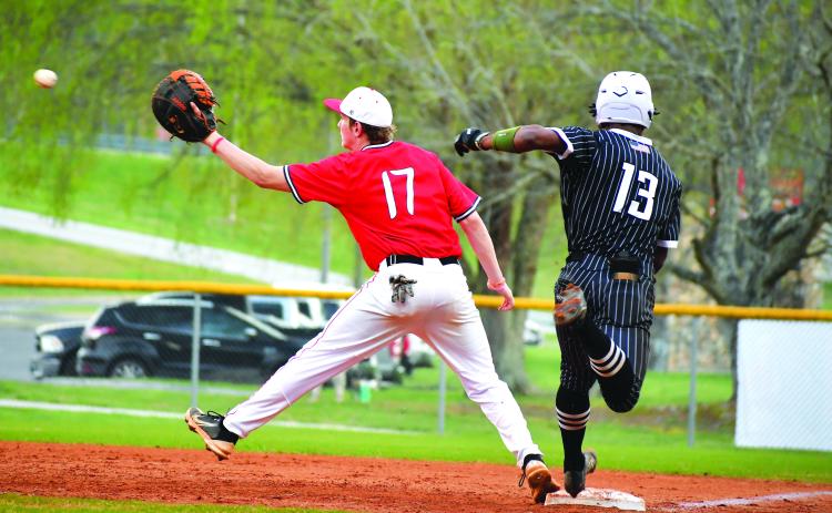 Luke Morey/The Clayton Tribune. Tallulah Falls senior Frankey Moree beats out a throw to Rabun County first baseman Elvis Hunt on Tuesday, April 4. Moree and the Indians have now clinched a playoff berth with six games remaining in the regular season.