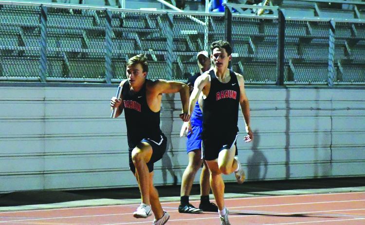 Luke Morey/The Clayton Tribune. Hayden Deslich passes the baton off to Paul Picciotti during the 4X400 on Wednesday, April 19. The relay team of Deslich, Picciotti, Hayden Smith and Willie Goodwyn finished the relay with a time of 3:34.