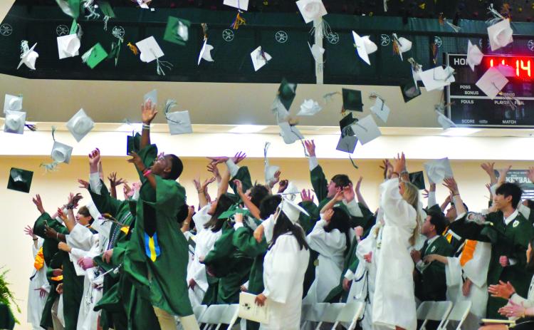 Enoch Autry/The Clayton Tribune. The Class of 2023 toss their caps into the air in celebration of graduating from the Tallulah Falls School.