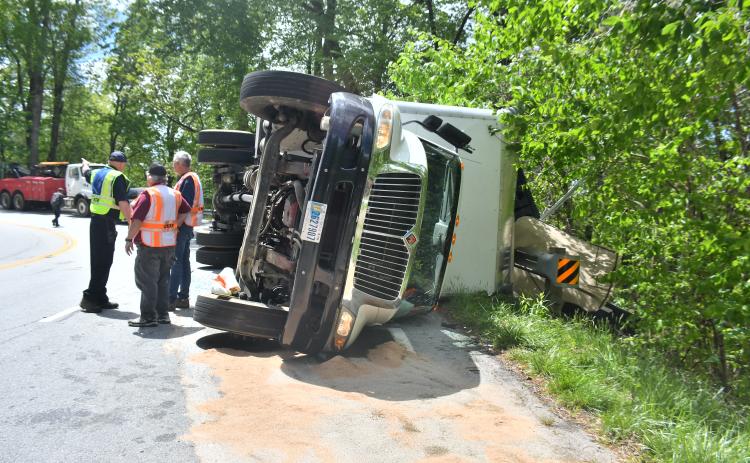 Megan Broome/The Clayton Tribune. Sky Valley Police Chief Vaughn Estes, Sky Valley-Scaly Mountain Volunteer Fire & Rescue Chief Ken Sigler and firefighters analyze the crash scene on Highway 246 just past Sky Valley Overlook in Macon County, North Carolina limits Monday, May 1.