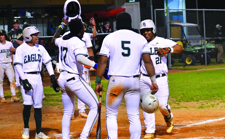 Luke Morey/The Clayton Tribune. Rabun Gap sophomore catcher Jeffrey Diaz (21) celebrates crossing the plate after hitting a grand slam that scored senior Armani Guzman (5), sophomore Denajh Williams (17) and senior Keesean Campbell (1). Diaz is leading the team with six home runs on the season.