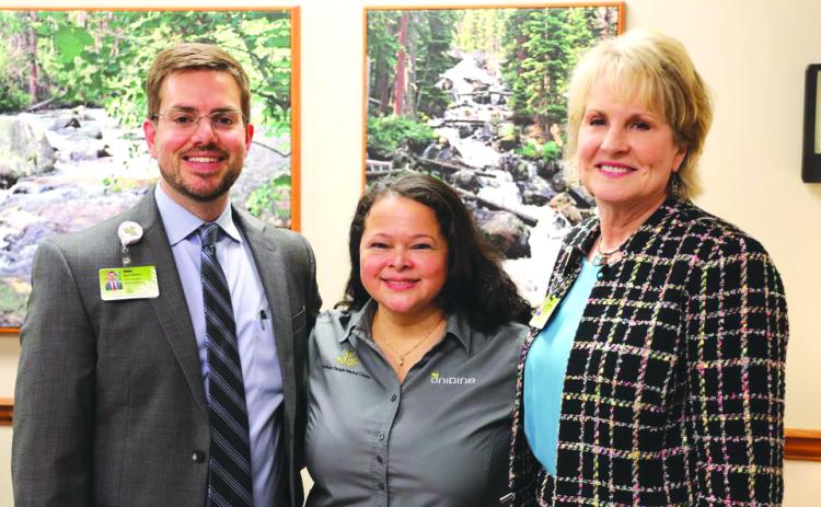 Submitted photo. Lidia Sorto has been with Northeast Georgia Health System (NGHS) for 16 years, and was named Employee of the Year for her work in nutrition services. From left are Kevin Matson, vice president of oncology, orthopedic and rehabilitation services for NGHS; Lidia Sorto, cashier with nutrition services; Carol Burrell, president & CEO of NGHS.