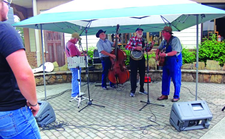 Submitted photo. The Tallulah Falls Band members Kerry Cash, of Mount Airy, on Dobro (from left); Bryan Addis, of Mount Airy, upright bass; Ben Johnson, of Gum Log, banjo; and Stanley Starnes, of Lawrenceville, guitar play at the Tallulah Gorge State Park’s 30th anniversary. The band has been together for 22 years and plays on Saturday nights in the Tallulah Falls city park.