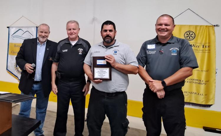 Megan Broome/The Clayton Tribune. Rabun County EMS Paramedic Jon Wilbanks is presented with the Clayton Rotary Club EMT/Paramedic of the Year award by Rotary Club of Clayton President Leif Ericson at a recent club meeting. Also pictured to celebrate Wilbanks’ accomplishments are EMS/911 Director Mike Carnes and Captain Trampes Stancil.
