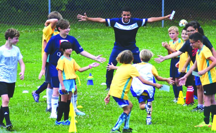 Enoch Autry/The Clayton Tribune. Claudio Lima waits for his campers to come in for a hug at the end of the camp held at Rabun County Recreation Department from June 19-23.