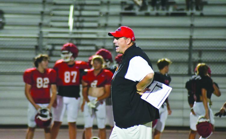 Enoch Autry/The Clayton Tribune. RCHS head coach Michael Davis watches his Wildcats during Midnight Madness practice on July 31. The Wildcats scrimmage Bowdon Friday.