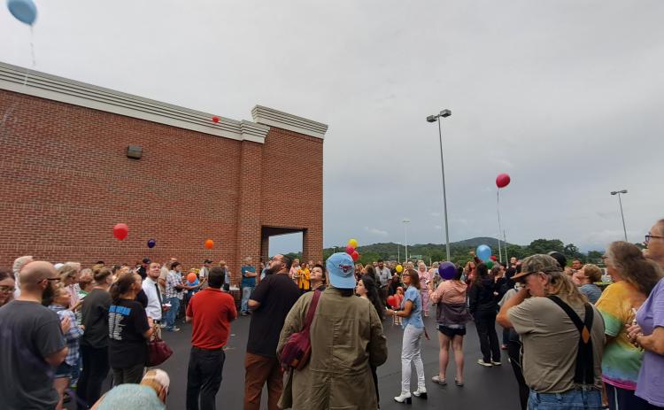 Megan Broome/The Clayton Tribune. Rabun County community members held a Candlelight Vigil at the north end of Ingles in Clayton Aug. 7 to honor the life of Rabun Gap man Frank Hanrahan, who suddenly died in a motor vehicle crash July 31. Hanrahan worked at the Clayton Ingles for 23 years and those honoring him lit candles, played “Amazing Grace” and released 23 balloons representing his 23 years at the business.