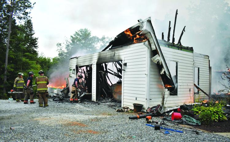 Megan Horn/The Clayton Tribune. Rabun County firefighters battle a structure fire on Sidetrack Lane on Aug. 27.