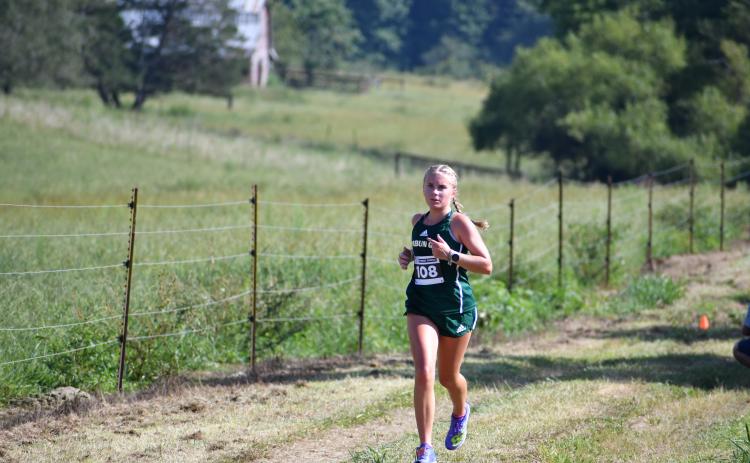 Wade Cheek/The Clayton Tribune. Rabun Gap freshman Bailey Brackett races to the finish line to take first place in the girls race on Aug. 31.