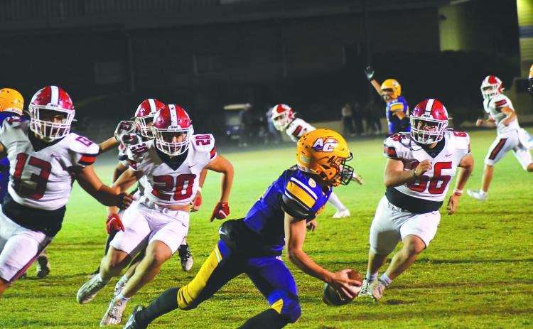 Wade Cheek/The Clayton Tribune. Athens Christian QB Matt Wiggins tries to avoid the Wildcats’ rush on Oct. 20 in a region contest won by RCHS 38-0. The Wildcats, who play Commerce this week, held the Eagles to negative 7 yards total offense.