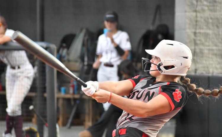 Wade Cheek/The Clayton Tribune. Lady Cat senior shortstop Mili Watts cracks a two-run home run over the right field wall to increase RCHS’s lead to 4-0 against Chestatee on Monday night. The Lady Cats won the game 13-1.